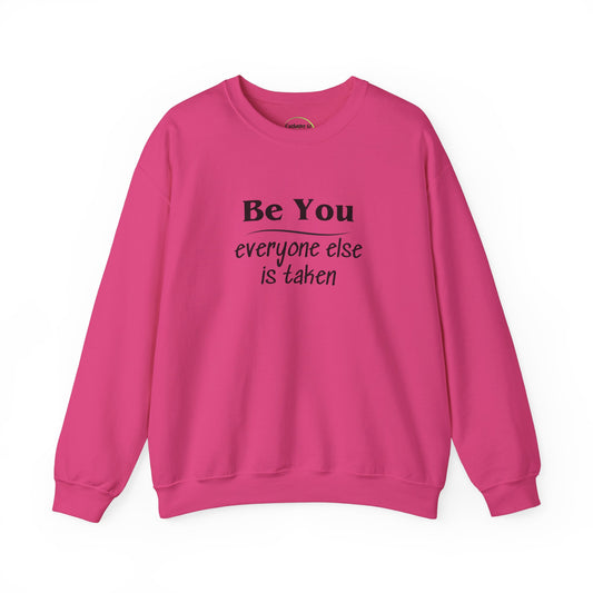 Long sleeve sweatshirt with crew neck, elastic waist and  at the wrist. Black letter text "Be You everyone else is taken. Text is on front and back. Bright Pink